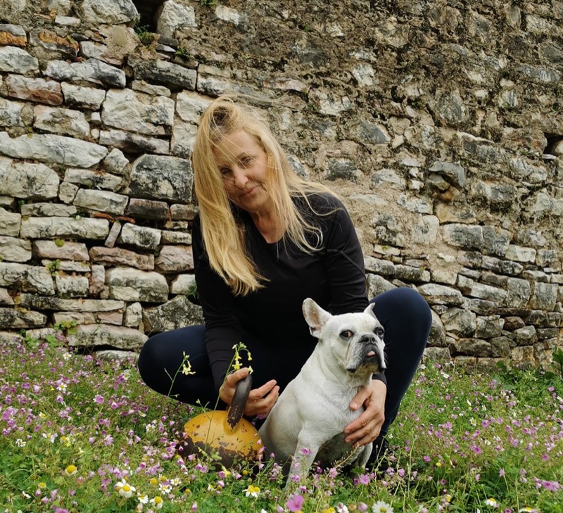 Anna Junghans, dog sitter in Kalamata, with her beloved dog Nacho in a wildflower field